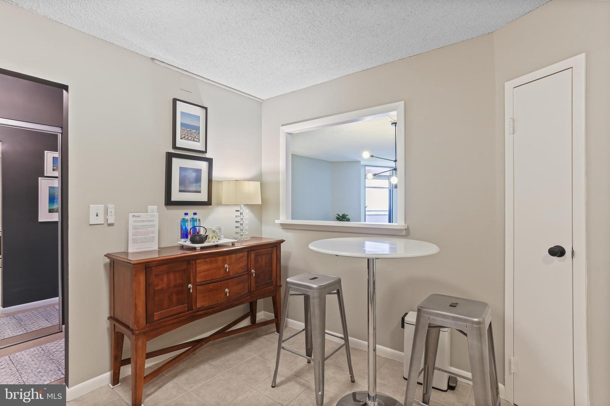 205 East Joppa Road, Unit 1907 Towson, MD 21286 - Photo 12 of 33 a room with two chair and a mirror