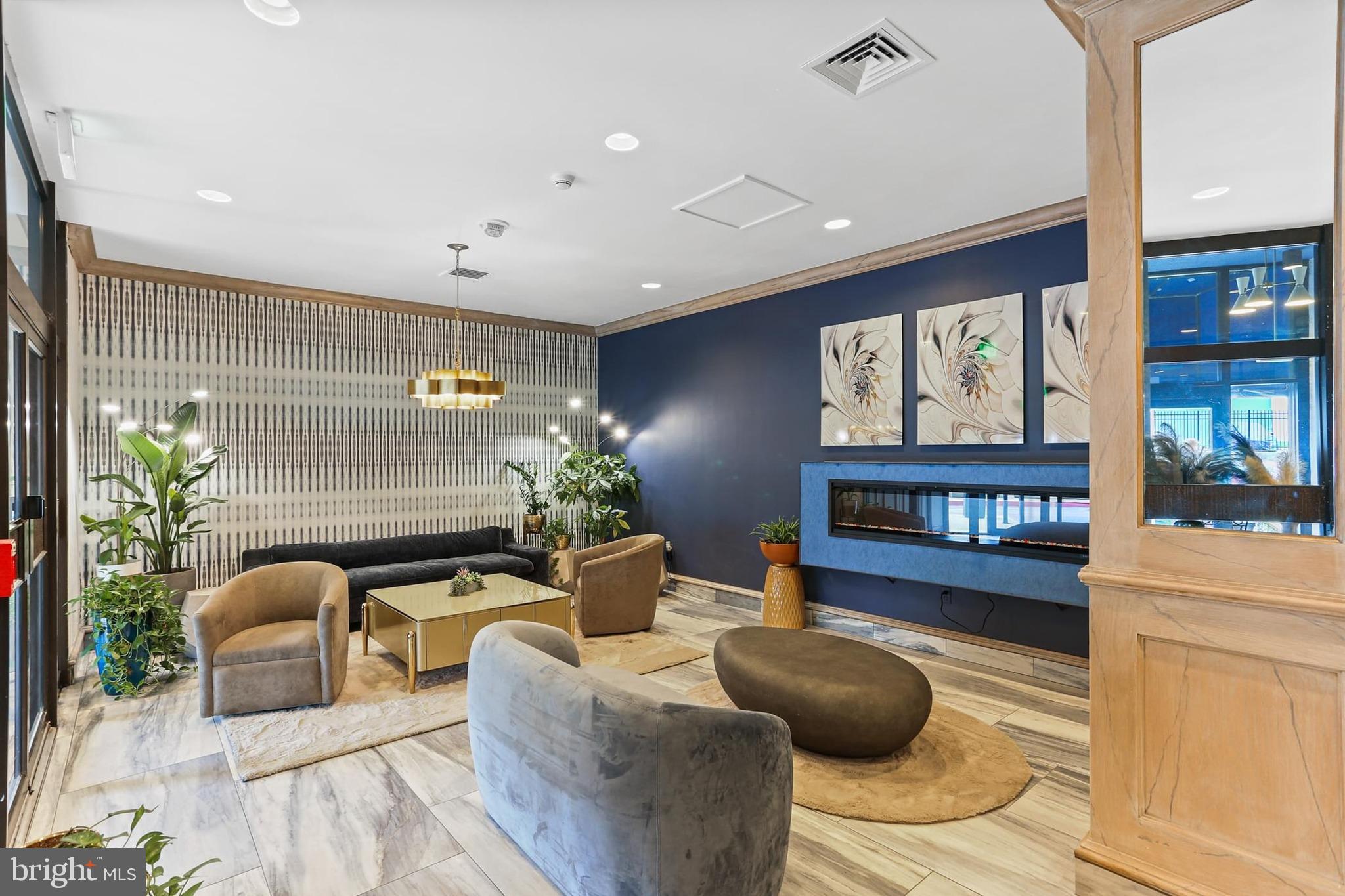 205 East Joppa Road, Unit 1907 Towson, MD 21286 - Photo 23 of 33 a living room with furniture and a potted plant