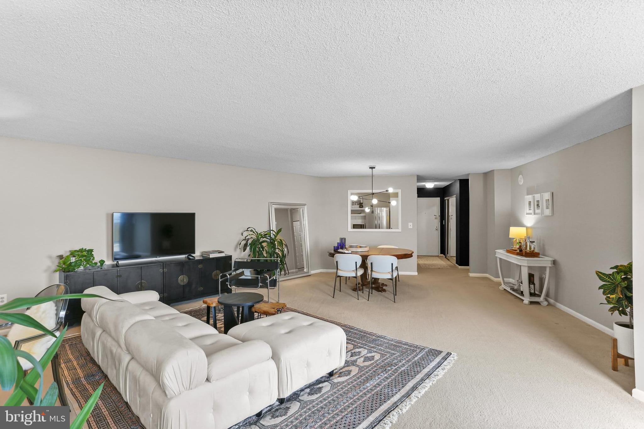 205 East Joppa Road, Unit 1907 Towson, MD 21286 - Photo 7 of 33 a living room with furniture and a flat screen tv