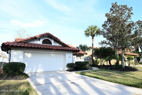 a house with palm tree in front of it