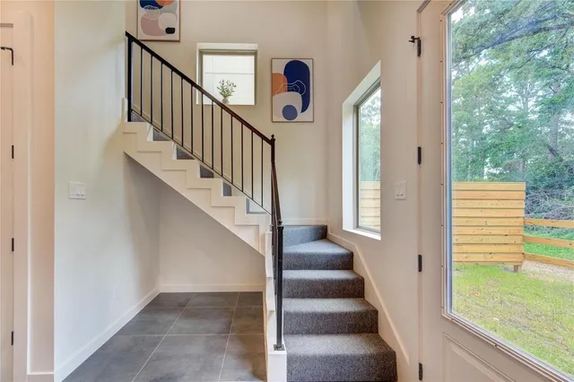 a view of entryway and hall with wooden floor