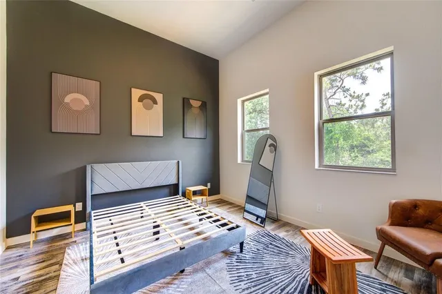 a bedroom with furniture and a window