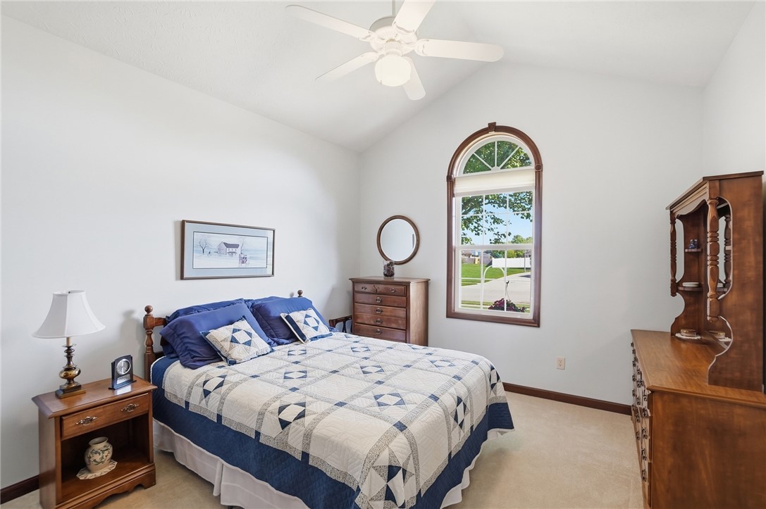 710 Governors Road Troy, OH 45373 - Photo 25 of 56 This airy bedroom features high ceilings and a striking arched window, offering a serene personal retreat.