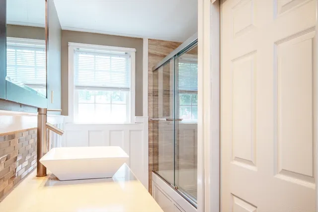 a white bath tub sitting next to a window