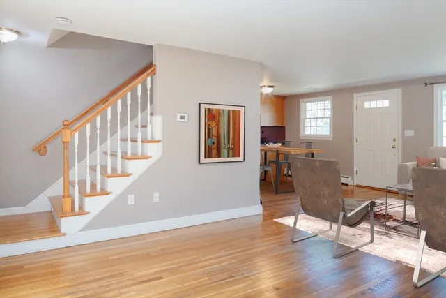 a view of a livingroom with wooden floor and furniture
