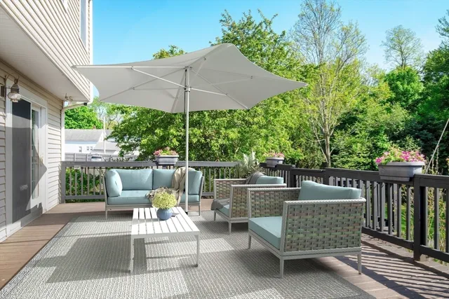 a view of a roof deck with furniture