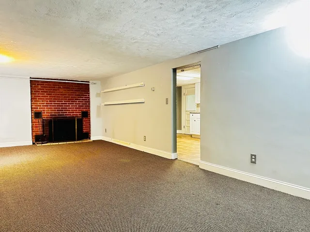 an empty room with a fireplace