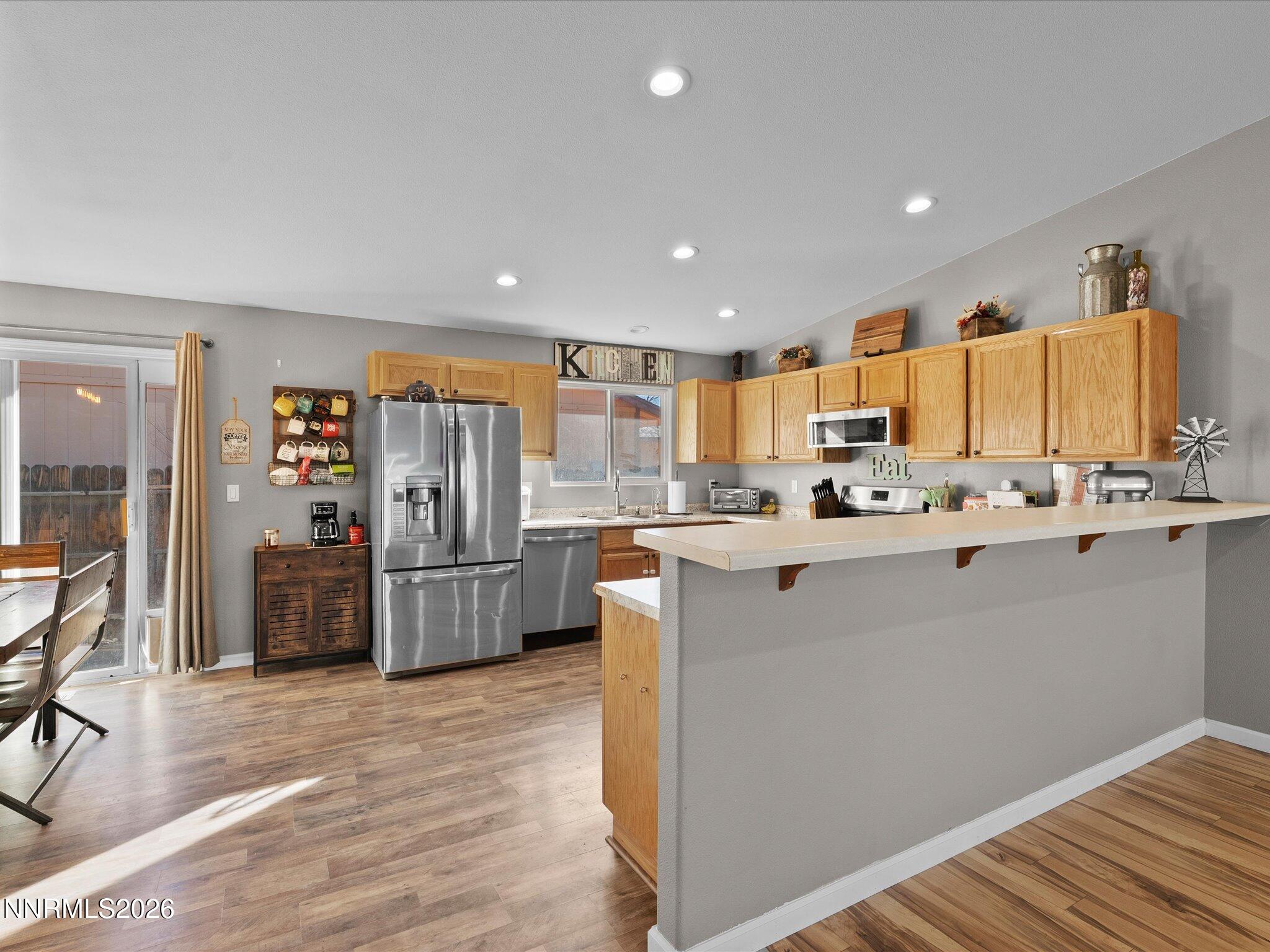 668 Farm Circle Fernley, NV 89408 - Photo 12 of 46 a kitchen with stainless steel appliances a refrigerator sink and cabinets