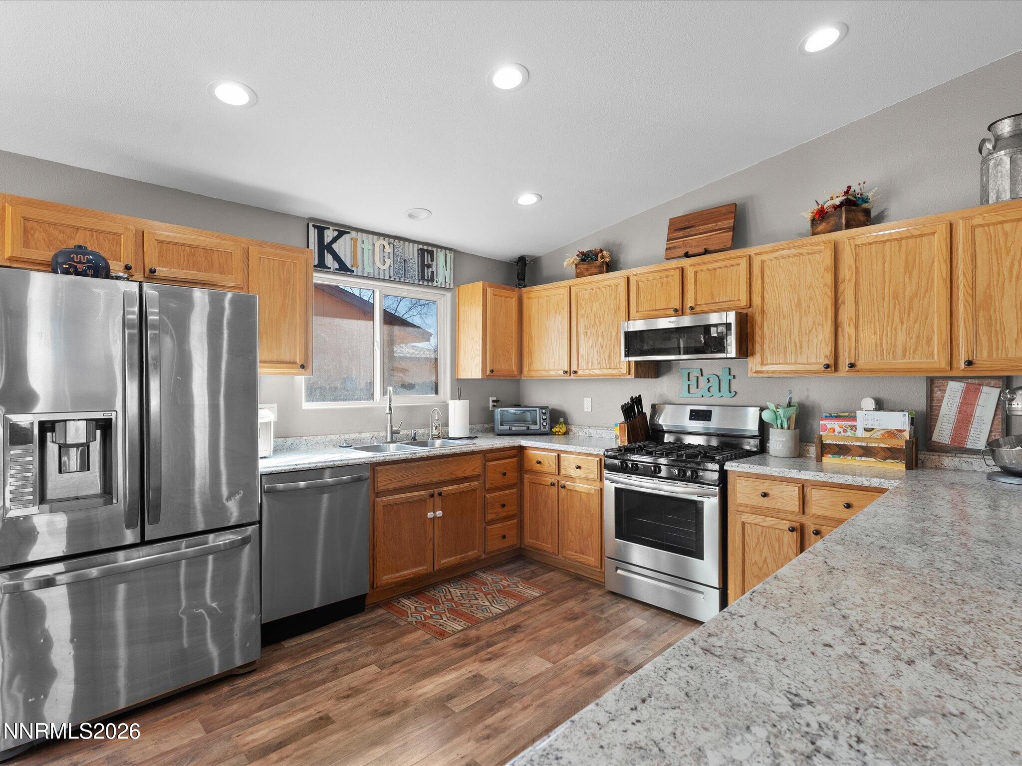 668 Farm Circle Fernley, NV 89408 - Photo 13 of 46 a kitchen with stainless steel appliances granite countertop a refrigerator a stove top oven a sink and dishwasher