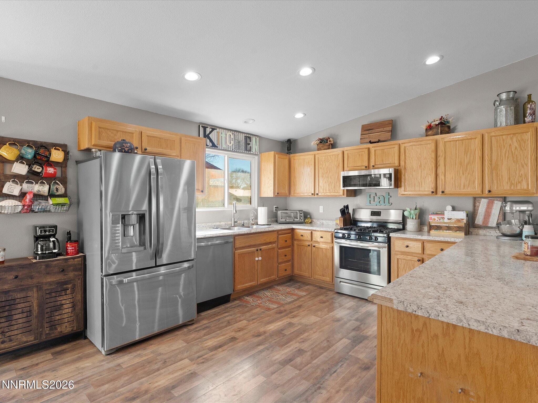 668 Farm Circle Fernley, NV 89408 - Photo 14 of 46 a kitchen with granite countertop stainless steel appliances a refrigerator a stove top oven and sink