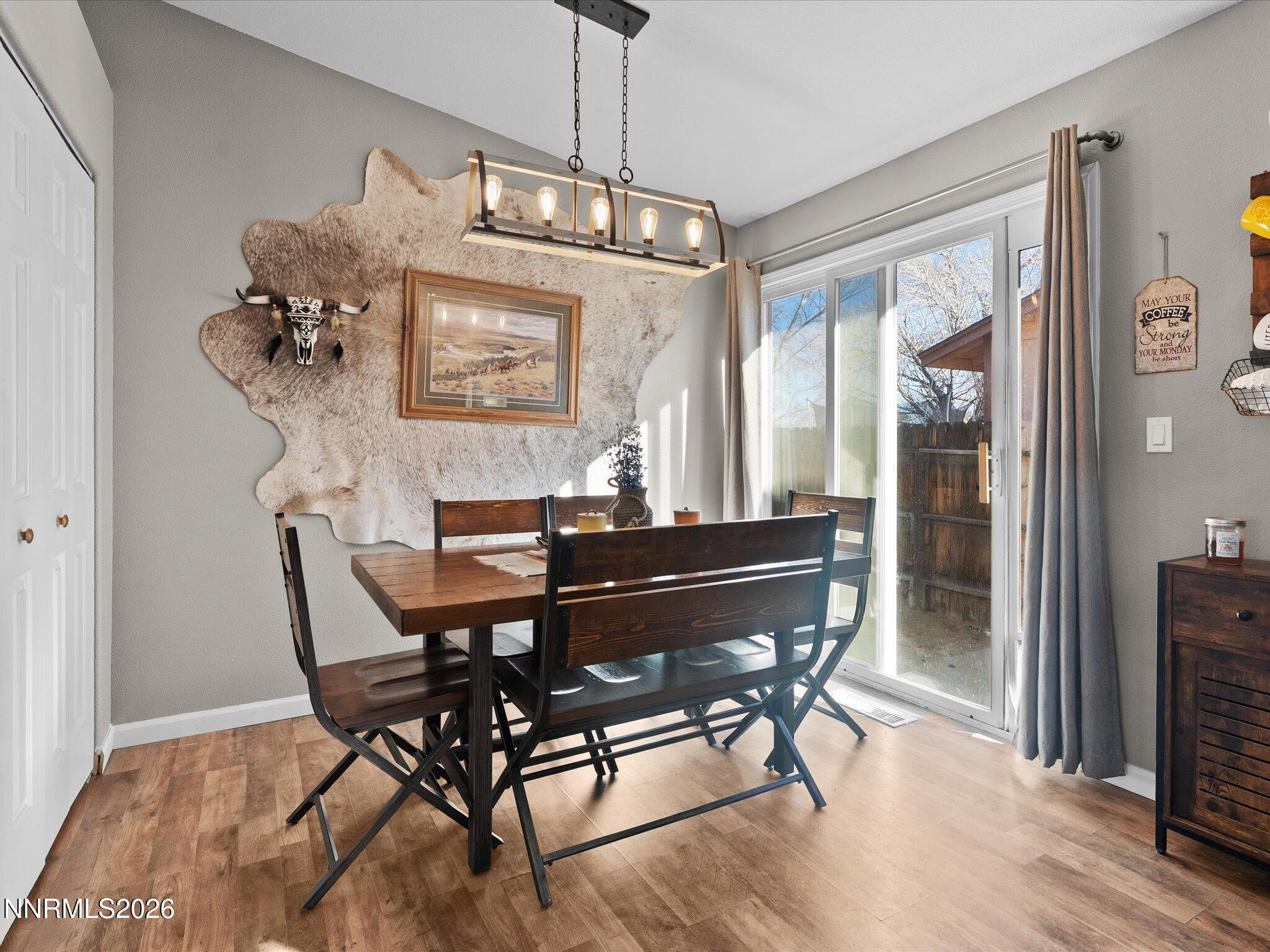668 Farm Circle Fernley, NV 89408 - Photo 19 of 46 a dining room with furniture potted plants and wooden floor