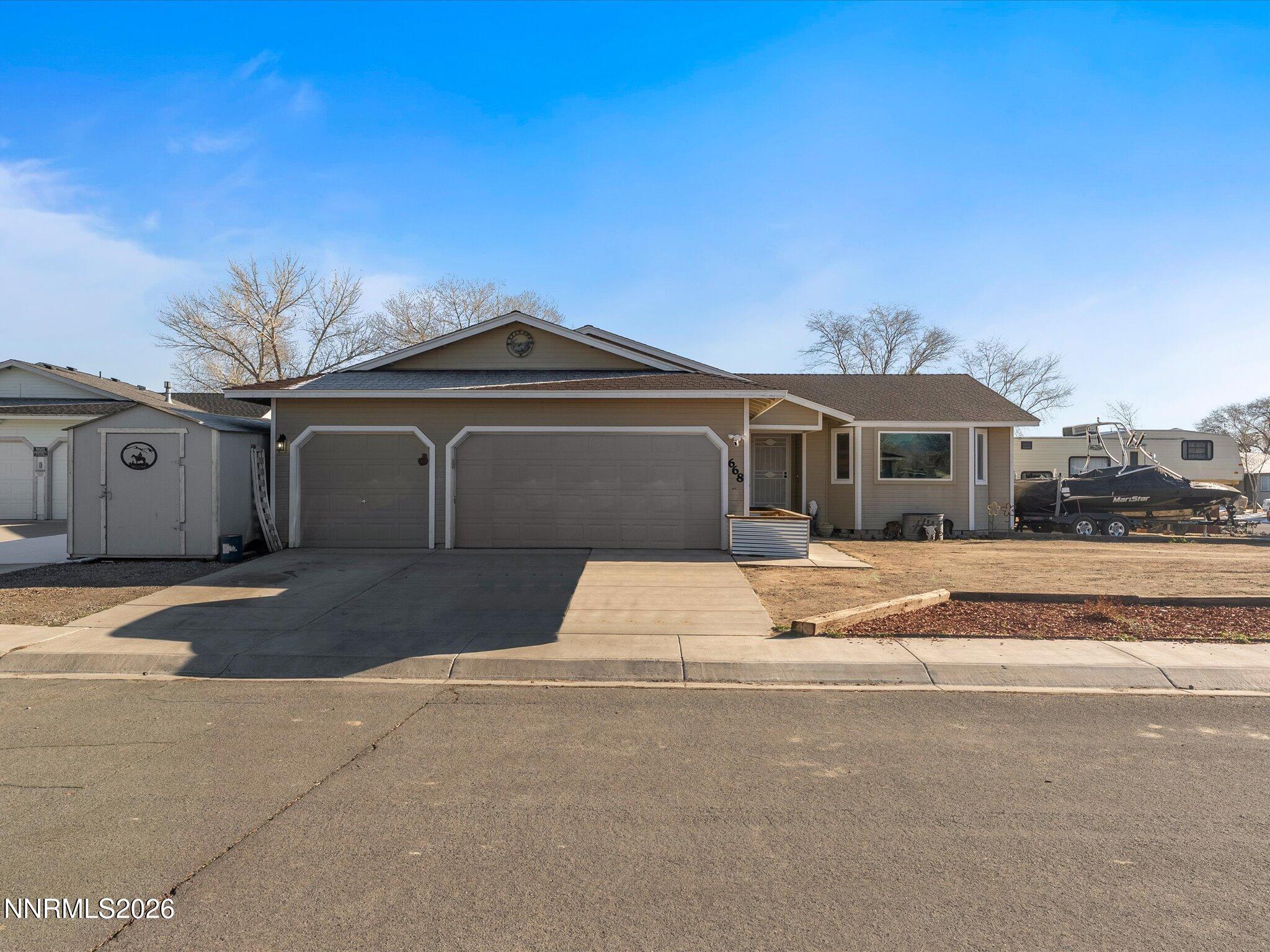 668 Farm Circle Fernley, NV 89408 - Photo 2 of 46 a front view of a house with a yard