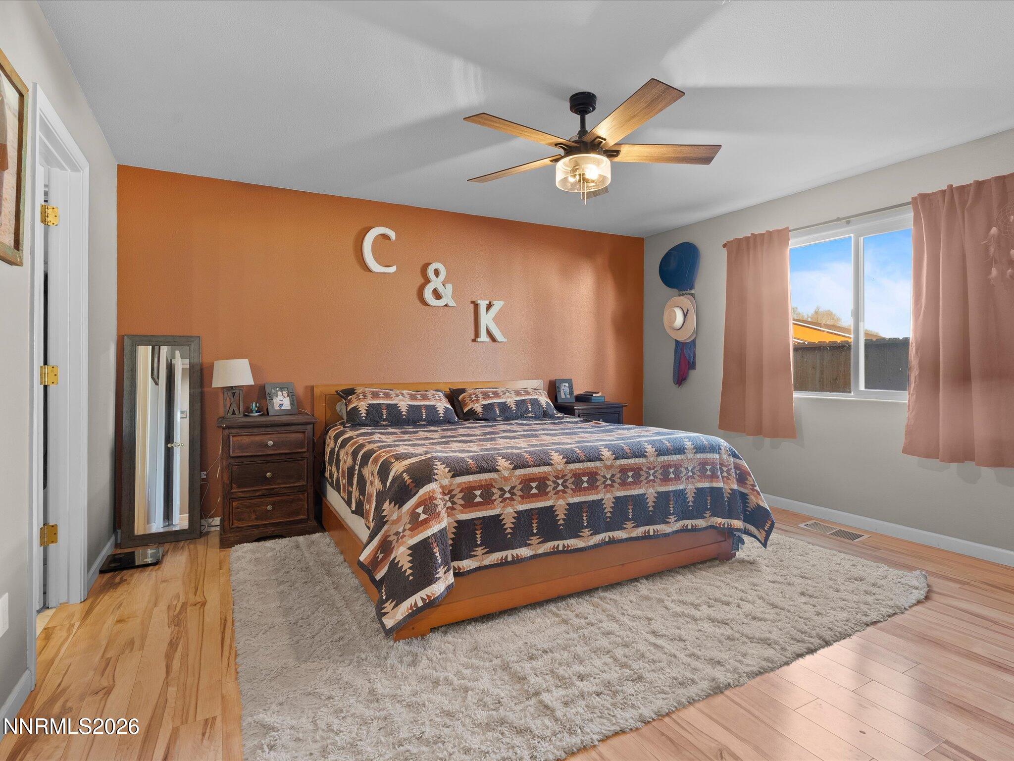 668 Farm Circle Fernley, NV 89408 - Photo 22 of 46 a bedroom with a bed and a ceiling fan