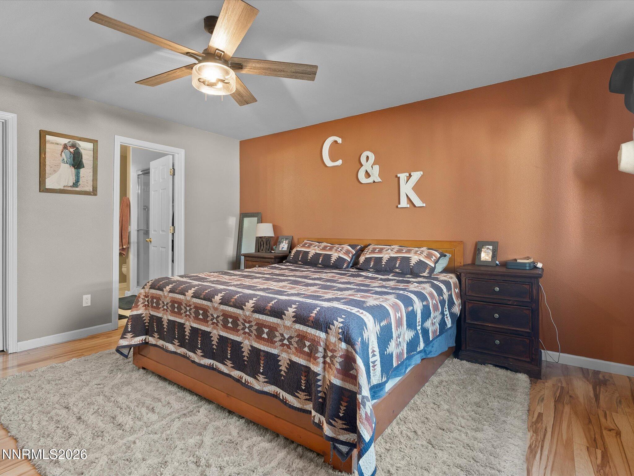 668 Farm Circle Fernley, NV 89408 - Photo 23 of 46 a bedroom with a bed and a chandelier