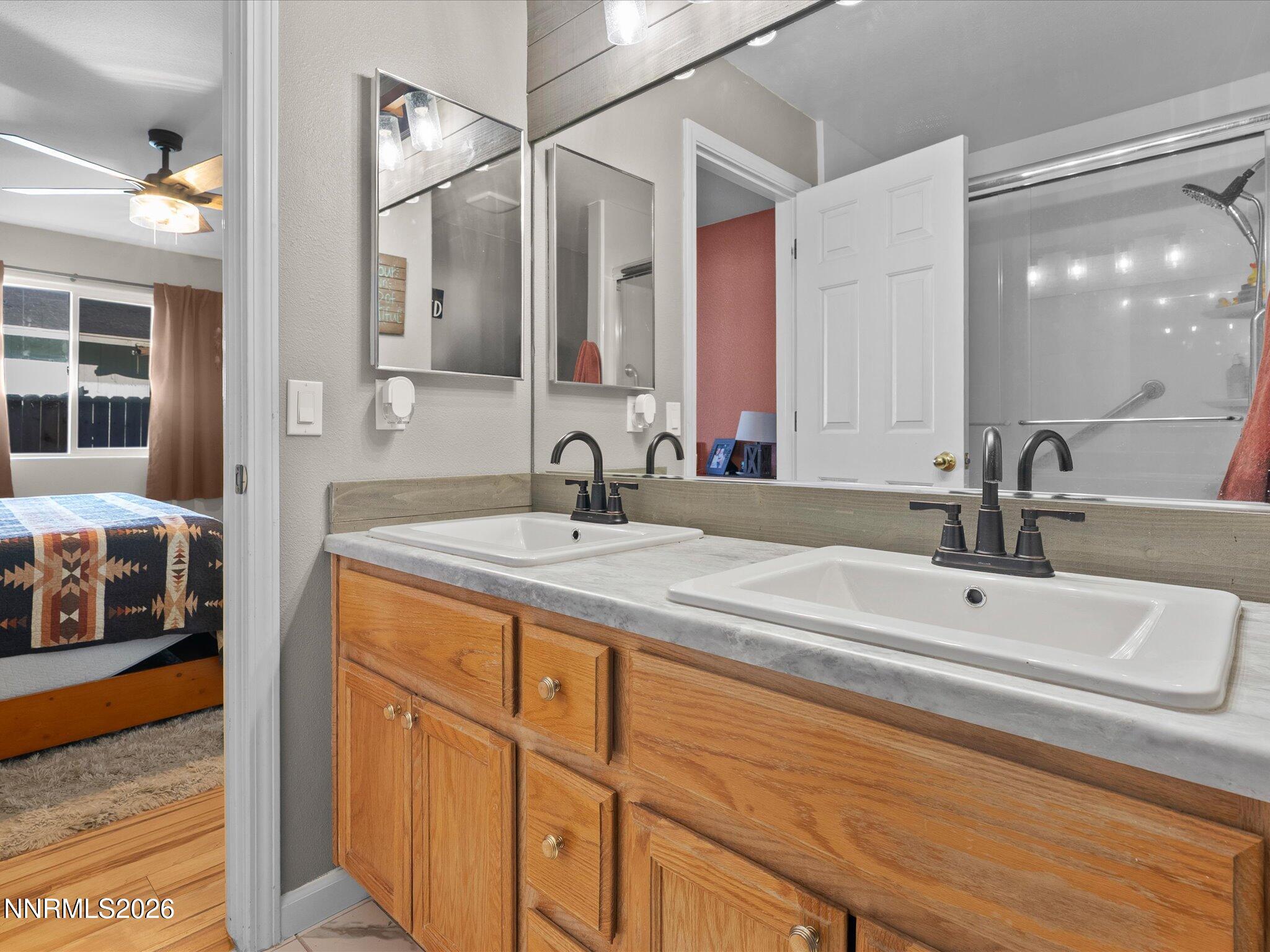 668 Farm Circle Fernley, NV 89408 - Photo 26 of 46 a bathroom with double vanity and a mirror