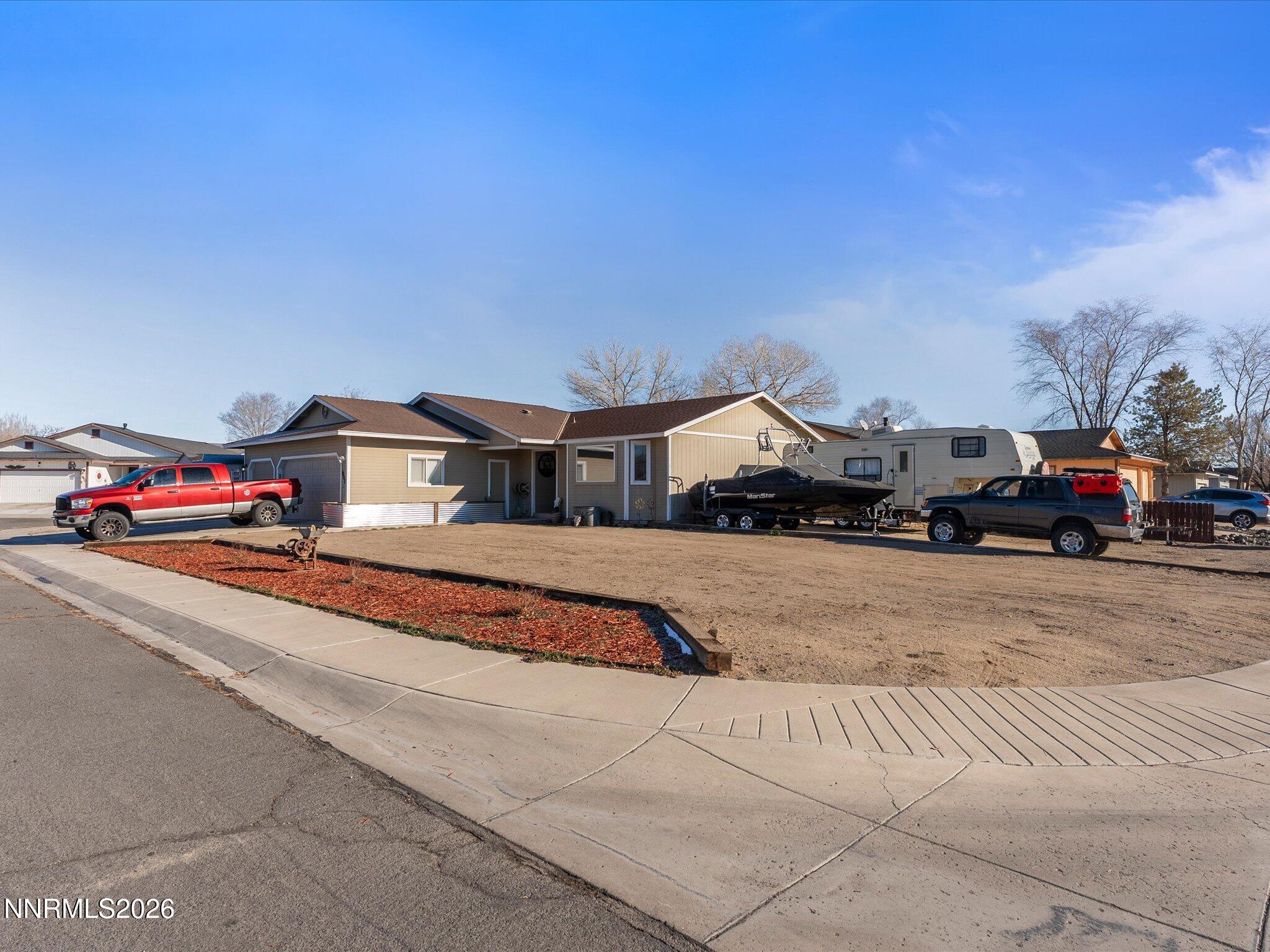 668 Farm Circle Fernley, NV 89408 - Photo 3 of 46 a cars parked on the side of a street