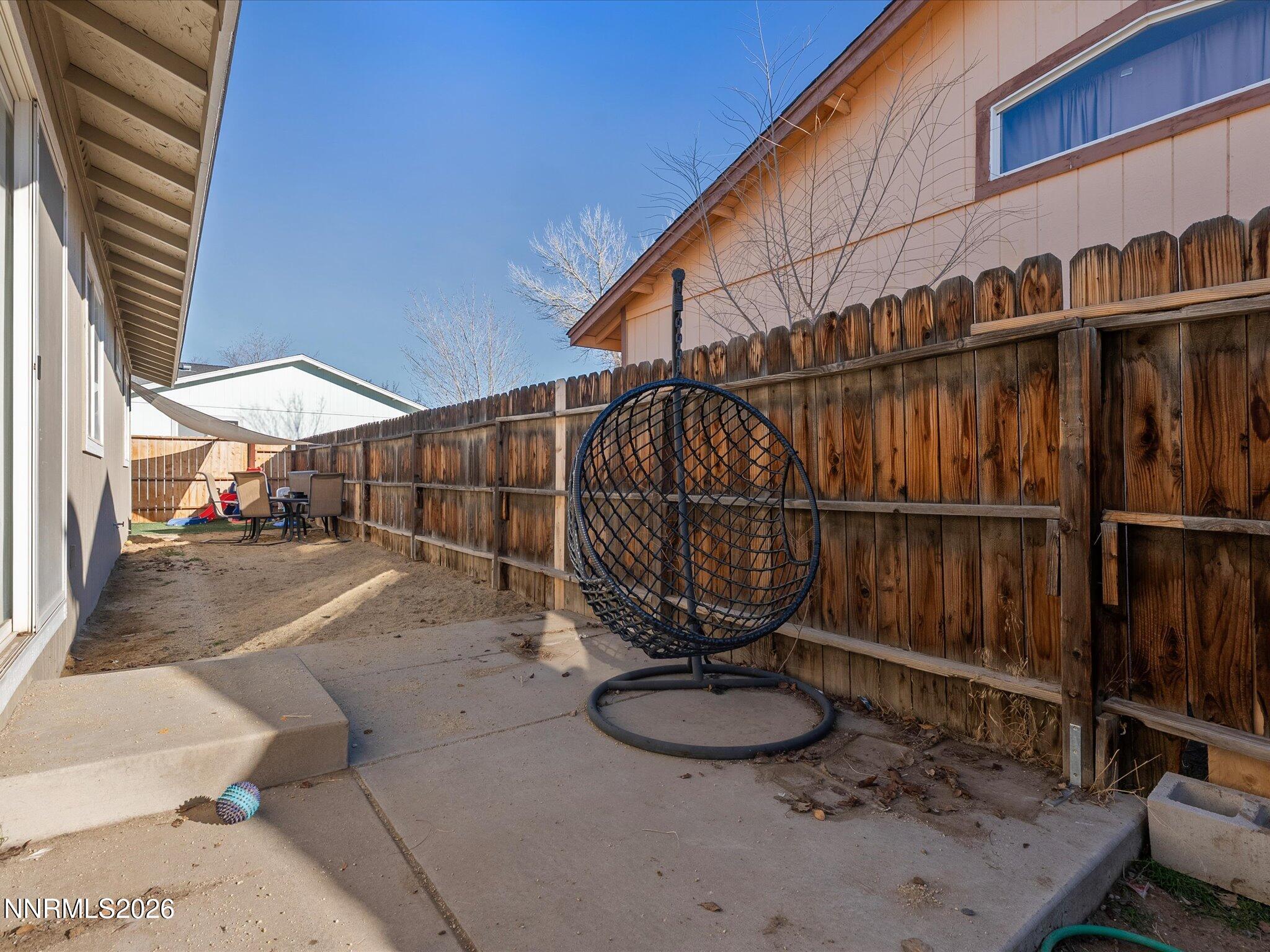 668 Farm Circle Fernley, NV 89408 - Photo 31 of 46 a backyard of a house with wooden floor and outdoor seating