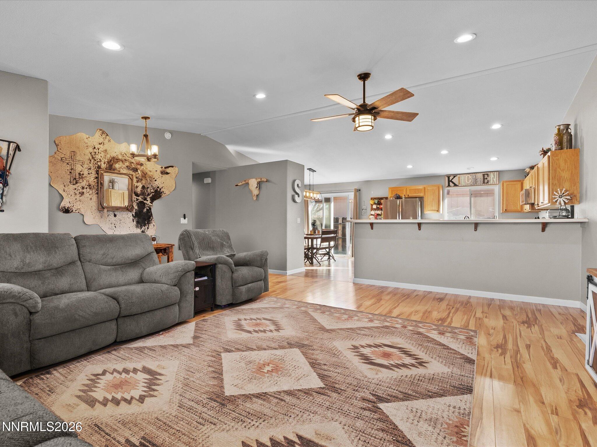 668 Farm Circle Fernley, NV 89408 - Photo 9 of 46 a living room with furniture and a chandelier