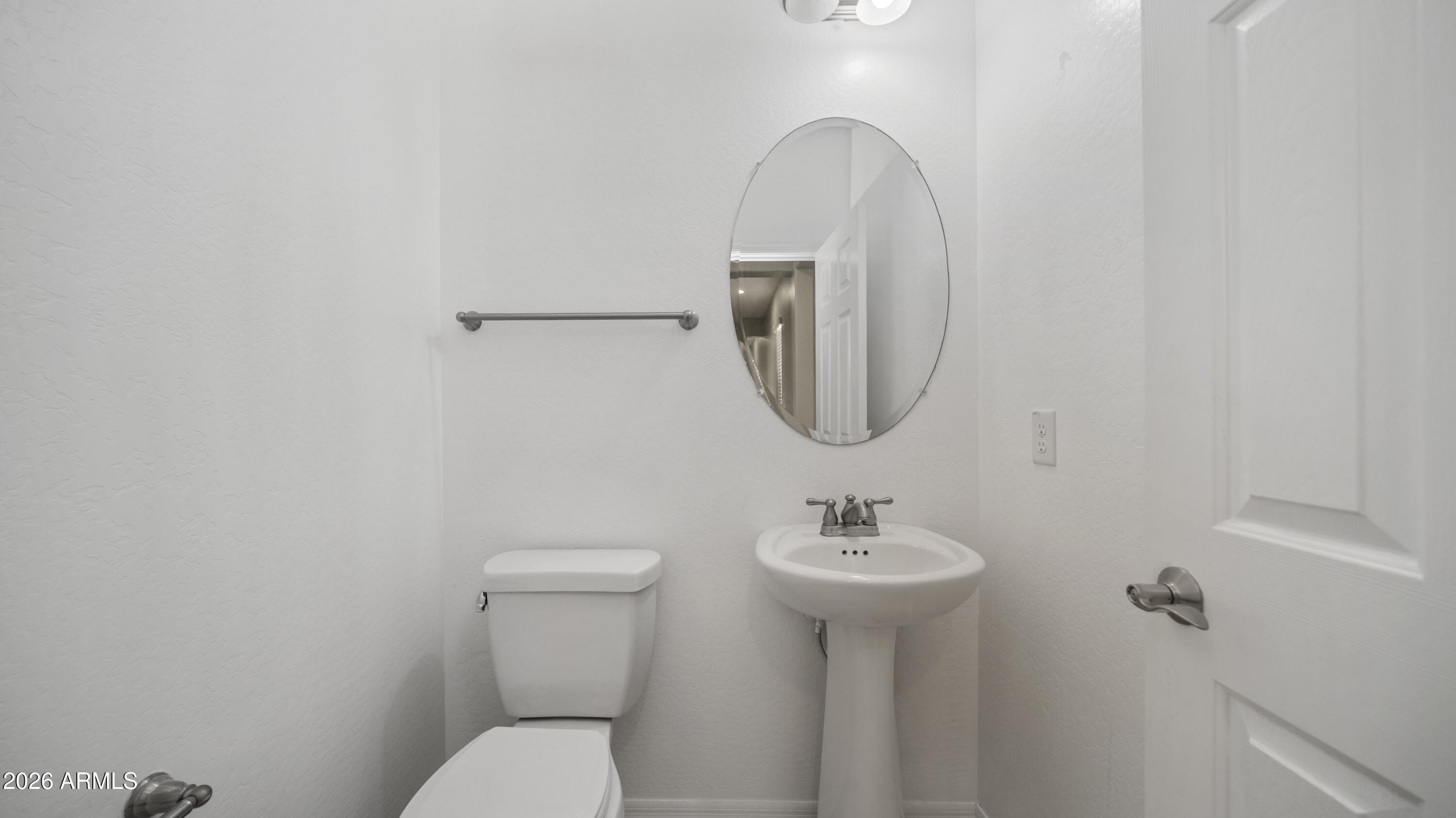 16159 West Granada Road Goodyear, AZ 85395 - Photo 31 of 41 a bathroom with a sink mirror and toilet