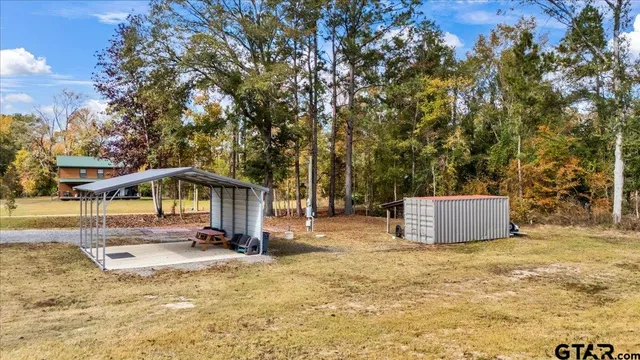a view of a big yard with a porch
