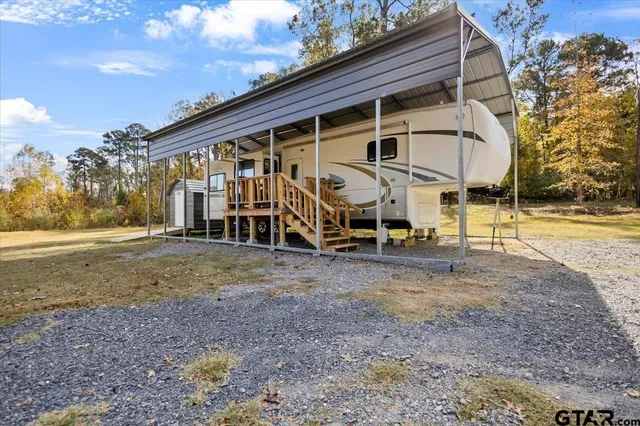 a view of a house with backyard and a tree