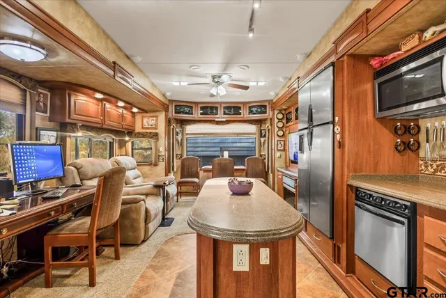 a kitchen with stainless steel appliances granite countertop a sink and a stove