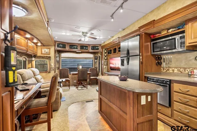 a large bedroom with a large bed and a chandelier