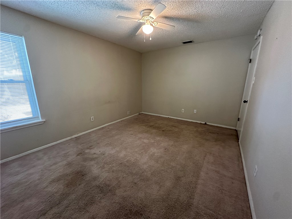 1506 Briar Street Portland, TX 78374 - Photo 17 of 40 an empty room with a window and a fan