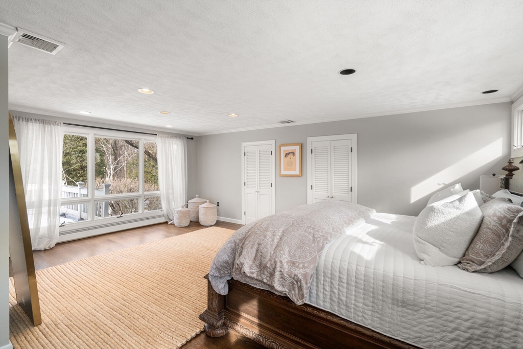20 Windsor Road Needham, MA 02492 - Photo 17 of 29 a bedroom with a large bed and three large window