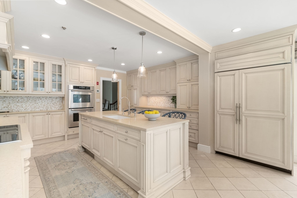 20 Windsor Road Needham, MA 02492 - Photo 8 of 29 a kitchen with stainless steel appliances kitchen island granite countertop a stove and a sink