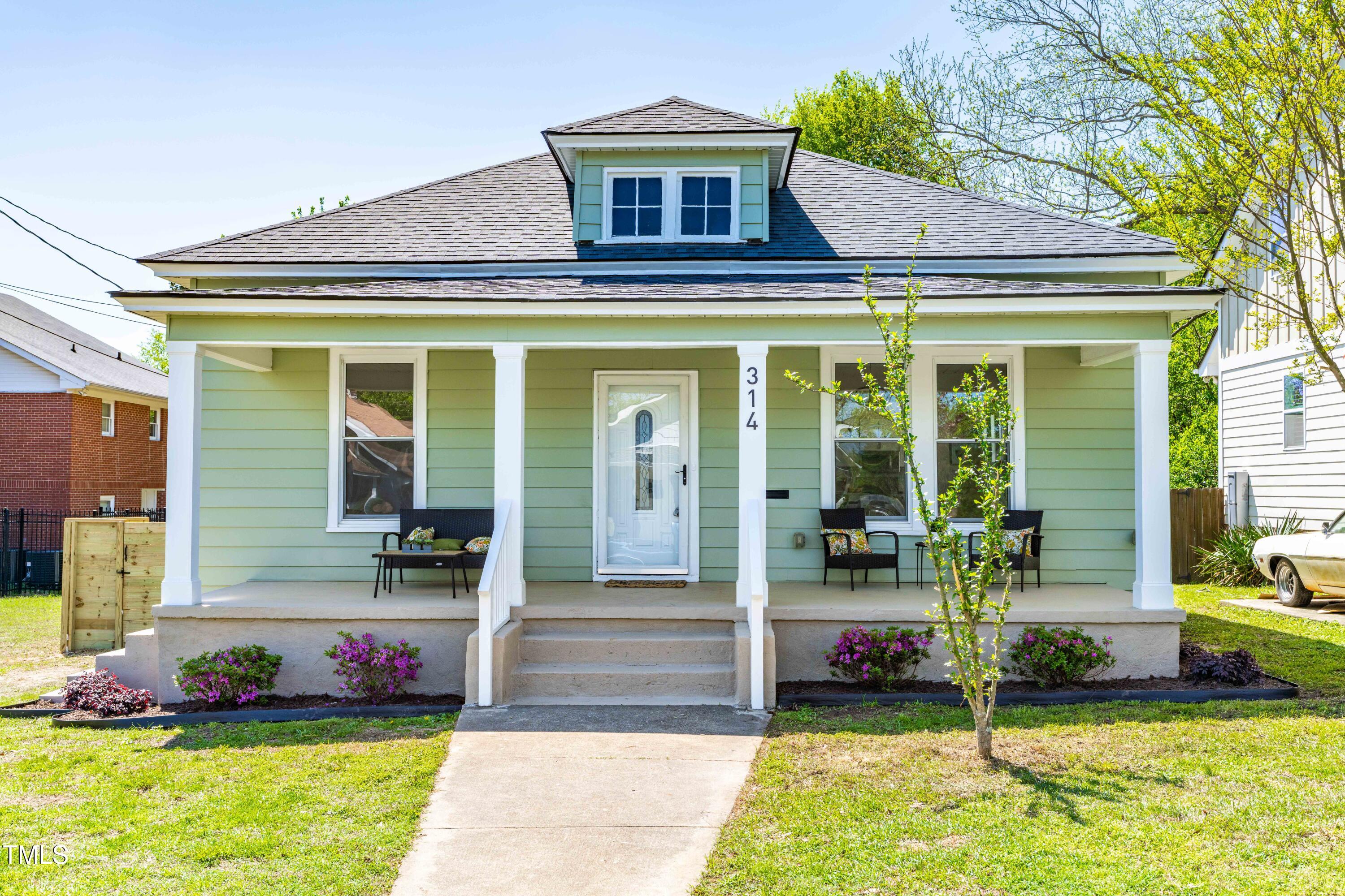 a front view of a house with a yard table and chairs