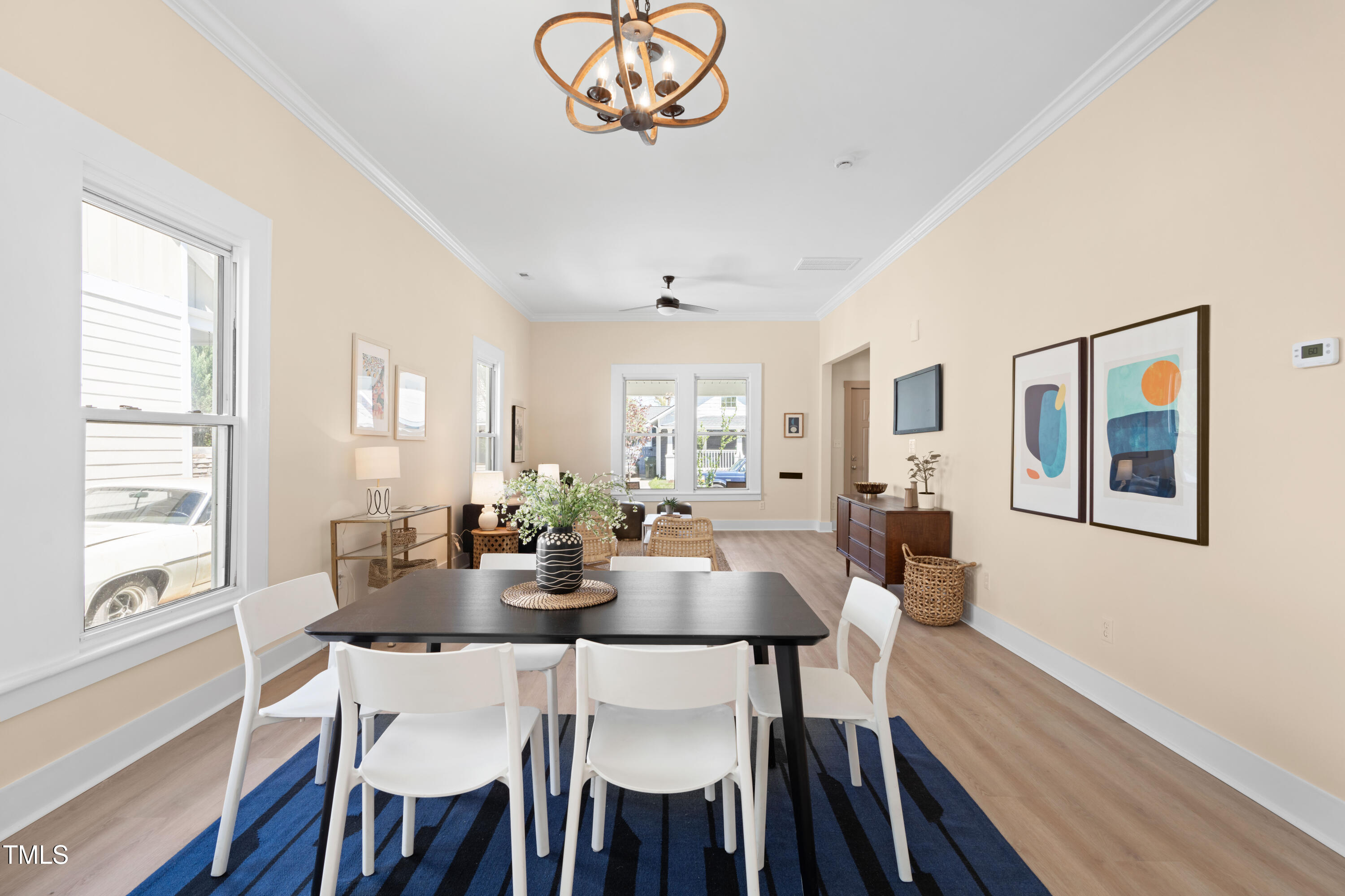 314 Bledsoe Avenue Raleigh, NC 27601 - Photo 7 of 21 a view of a dining room with furniture a chandelier and wooden floor
