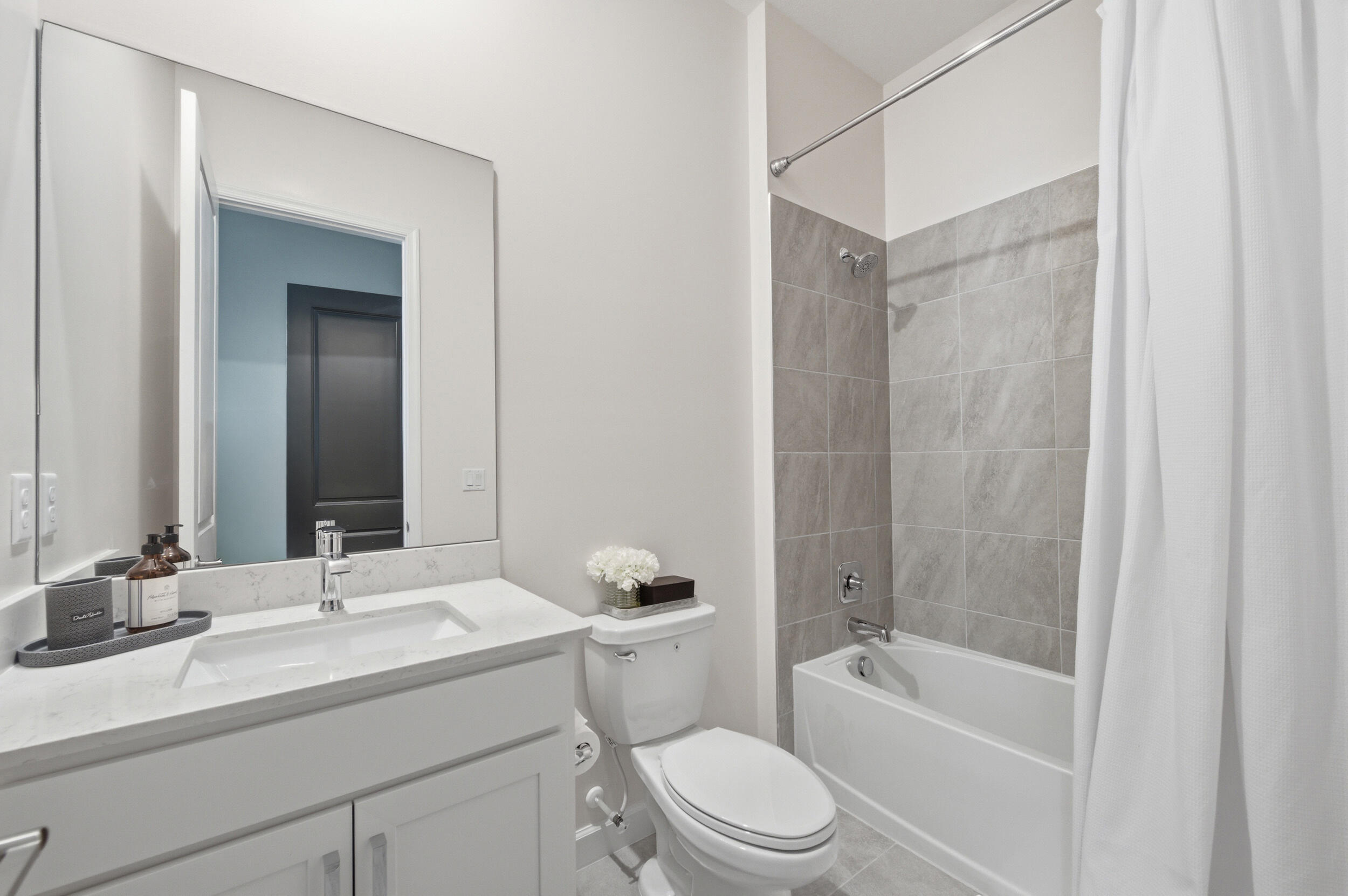 19230 Rolling Acres Road Loxahatchee, FL 33470 - Photo 21 of 58 a bathroom with a granite countertop sink a toilet and shower