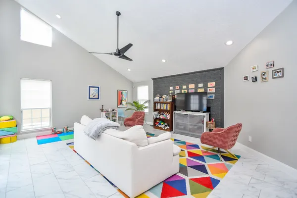 a living room with furniture and dining area