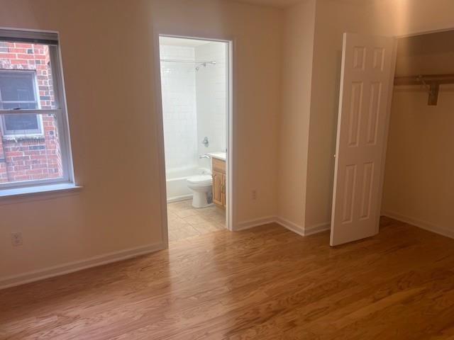 1031 Clinton Street, Unit 5B Hoboken, NJ 07030 - Photo 11 of 17 a view of an empty room with wooden floor and a bathroom