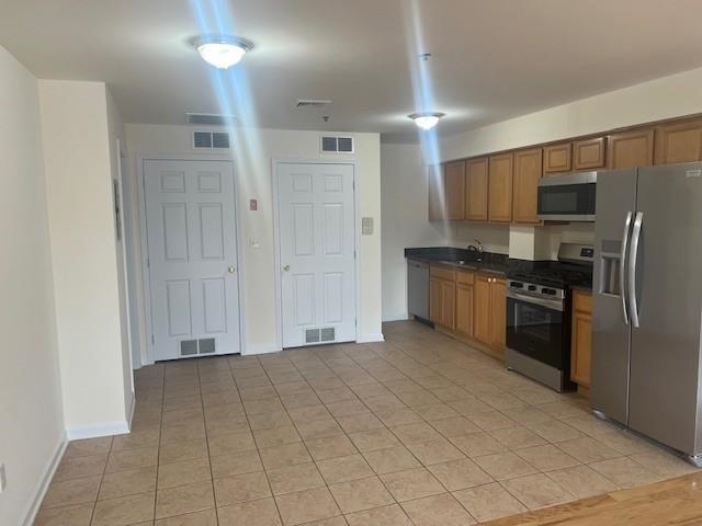 1031 Clinton Street, Unit 5B Hoboken, NJ 07030 - Photo 15 of 17 a kitchen with stainless steel appliances a refrigerator sink and cabinets