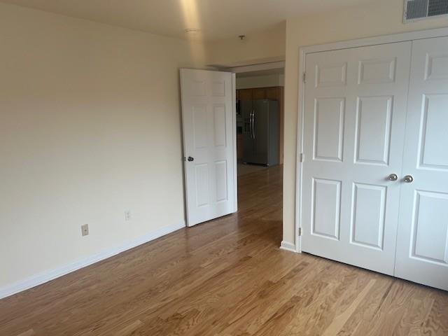 1031 Clinton Street, Unit 5B Hoboken, NJ 07030 - Photo 16 of 17 an empty room with wooden floor and closet area