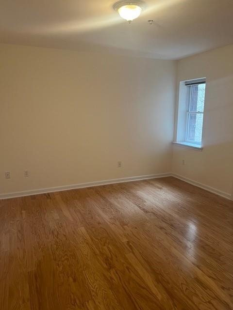 1031 Clinton Street, Unit 5B Hoboken, NJ 07030 - Photo 8 of 17 a view of an empty room with wooden floor and a window