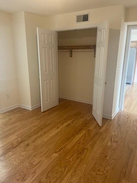 1031 Clinton Street, Unit 5B Hoboken, NJ 07030 - Photo 10 of 17 an empty room with a wooden door and wooden door