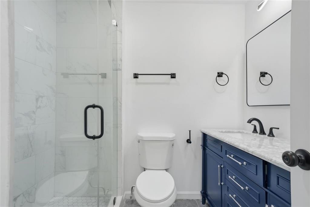 3920 Wedgefield Circle Decatur, GA 30035 - Photo 11 of 23 a bathroom with a granite countertop sink toilet and shower