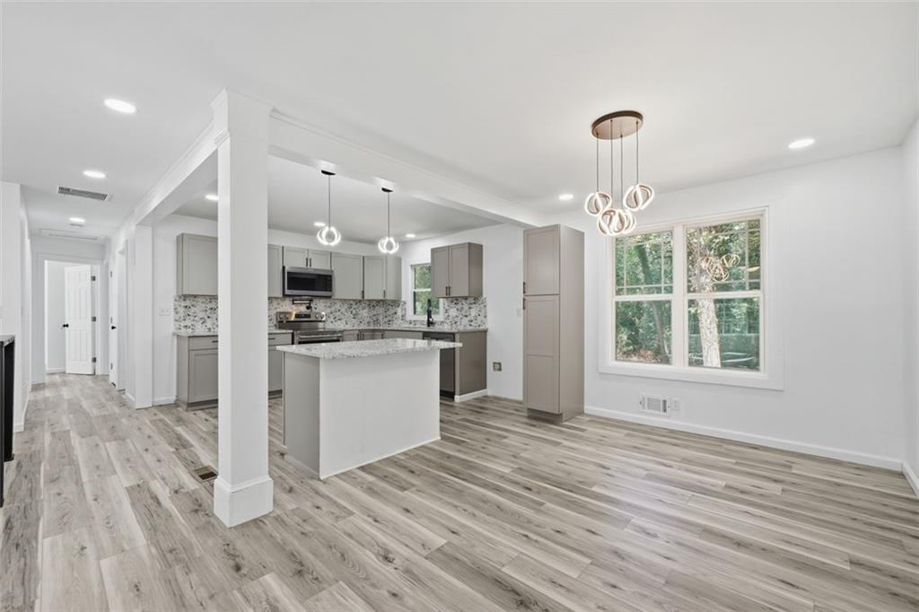 3920 Wedgefield Circle Decatur, GA 30035 - Photo 3 of 23 a open kitchen with kitchen island white cabinets and stainless steel appliances