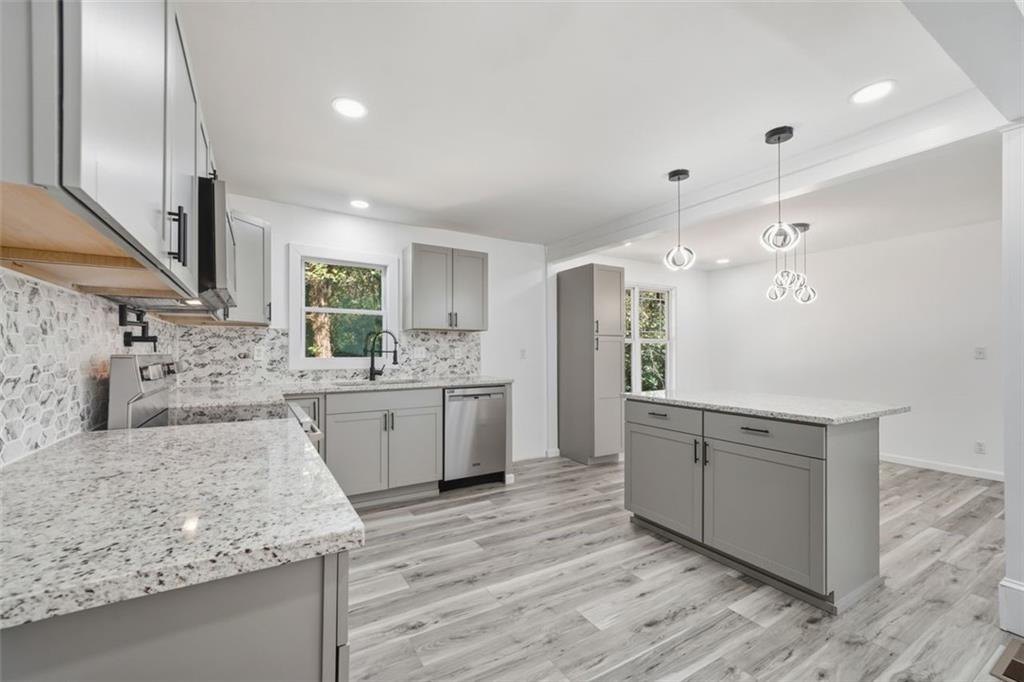 3920 Wedgefield Circle Decatur, GA 30035 - Photo 4 of 23 a large kitchen with kitchen island a sink stainless steel appliances and cabinets