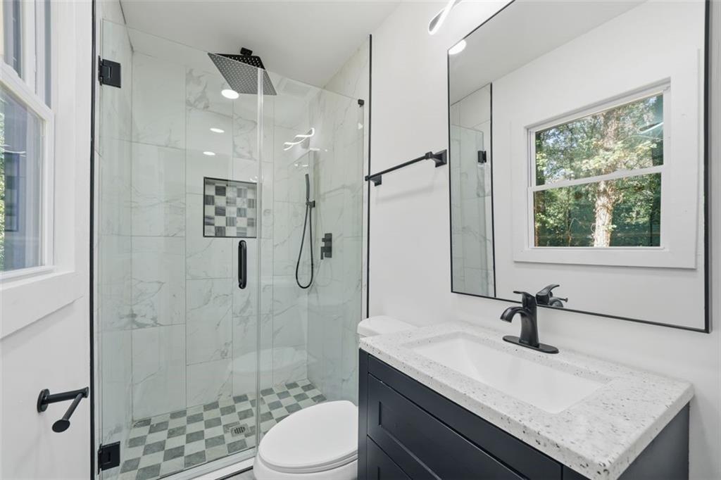 3920 Wedgefield Circle Decatur, GA 30035 - Photo 8 of 23 a bathroom with a granite countertop sink a toilet and shower