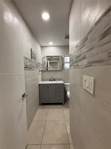 a bathroom with a tub a sink and a shower