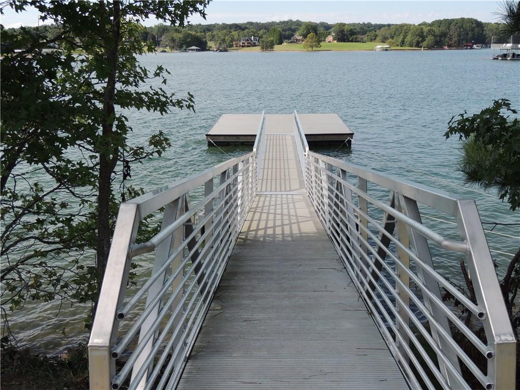 0 Indian Knoll Road Cumming, GA 30041 - Photo 28 of 37 a view of a balcony with wooden floor and lake view