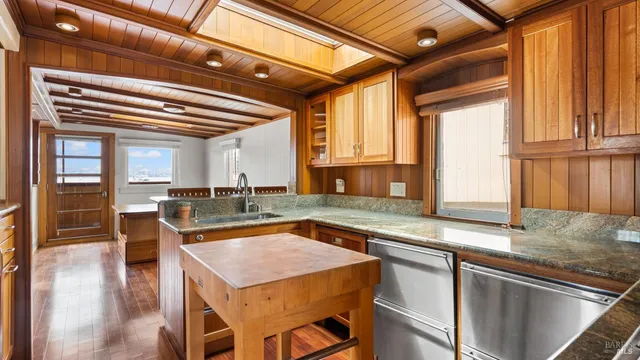 a kitchen with a stove a sink and a refrigerator