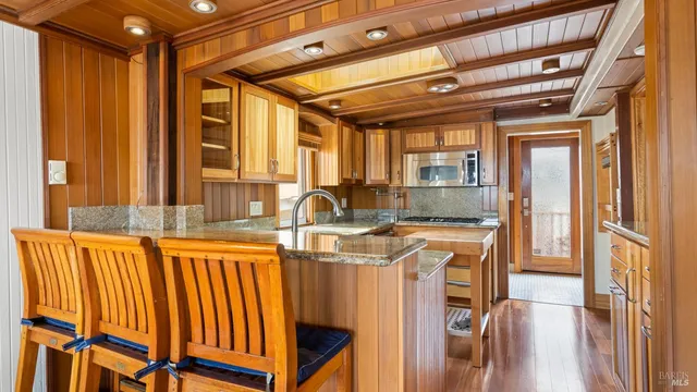 a kitchen with stainless steel appliances granite countertop a sink and a cabinets