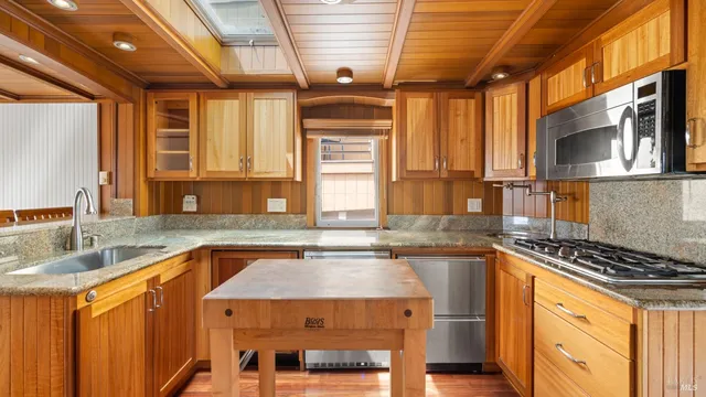 a kitchen that has a sink and a stove in it