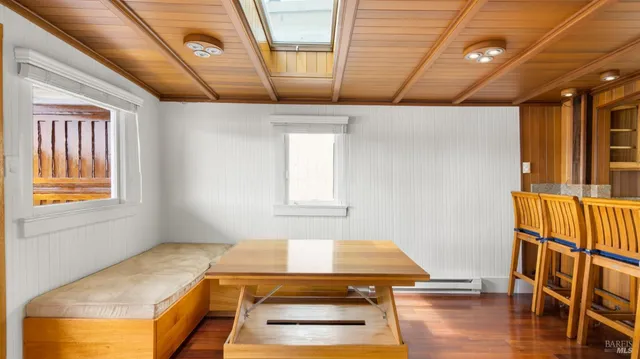 a room with wooden floor and pool table