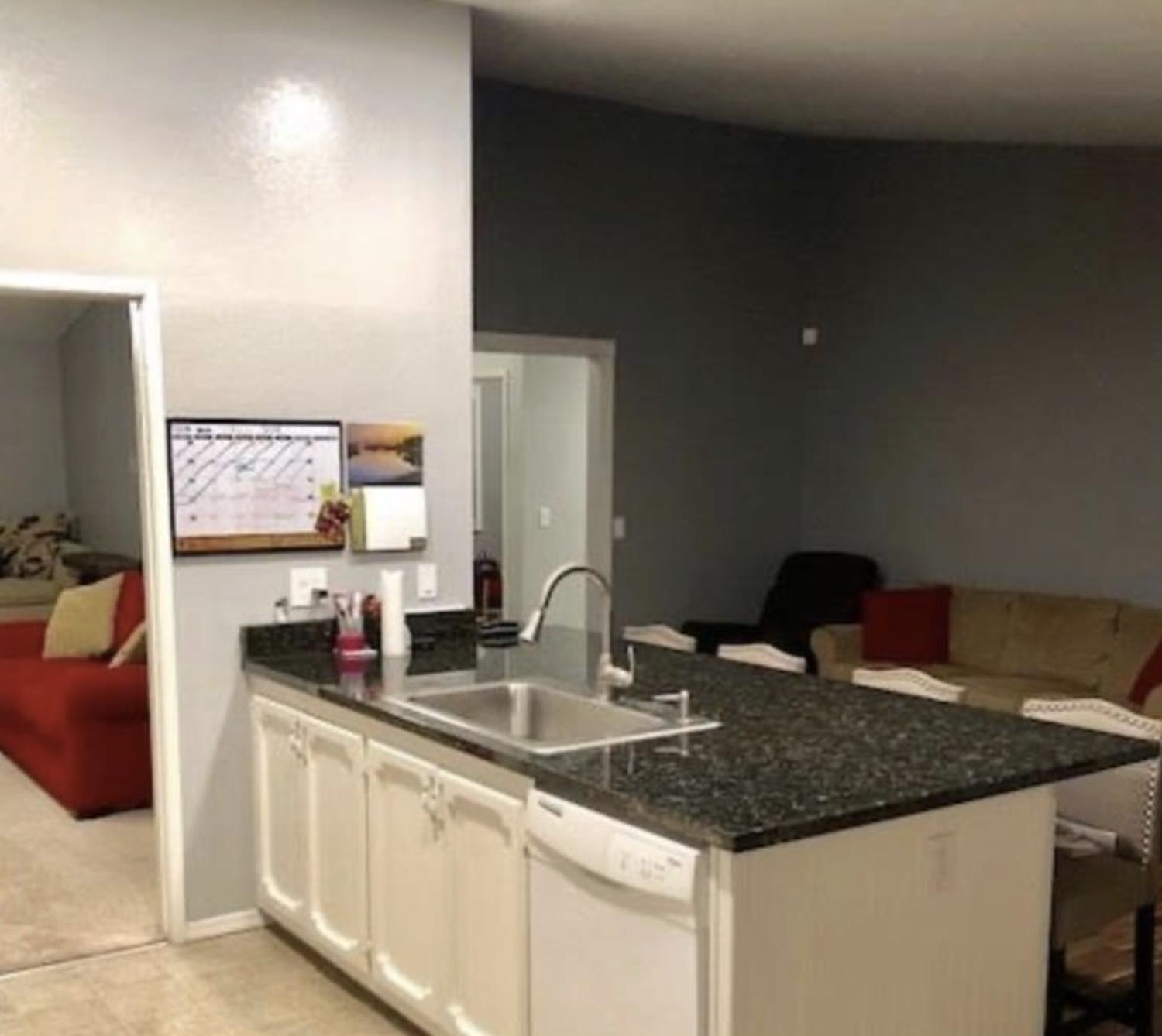 5250 Riverlake Road Discovery Bay, CA 94505 - Photo 18 of 18 Kitchen featuring a peninsula, a breakfast bar, dishwasher, white cabinetry, and open floor plan